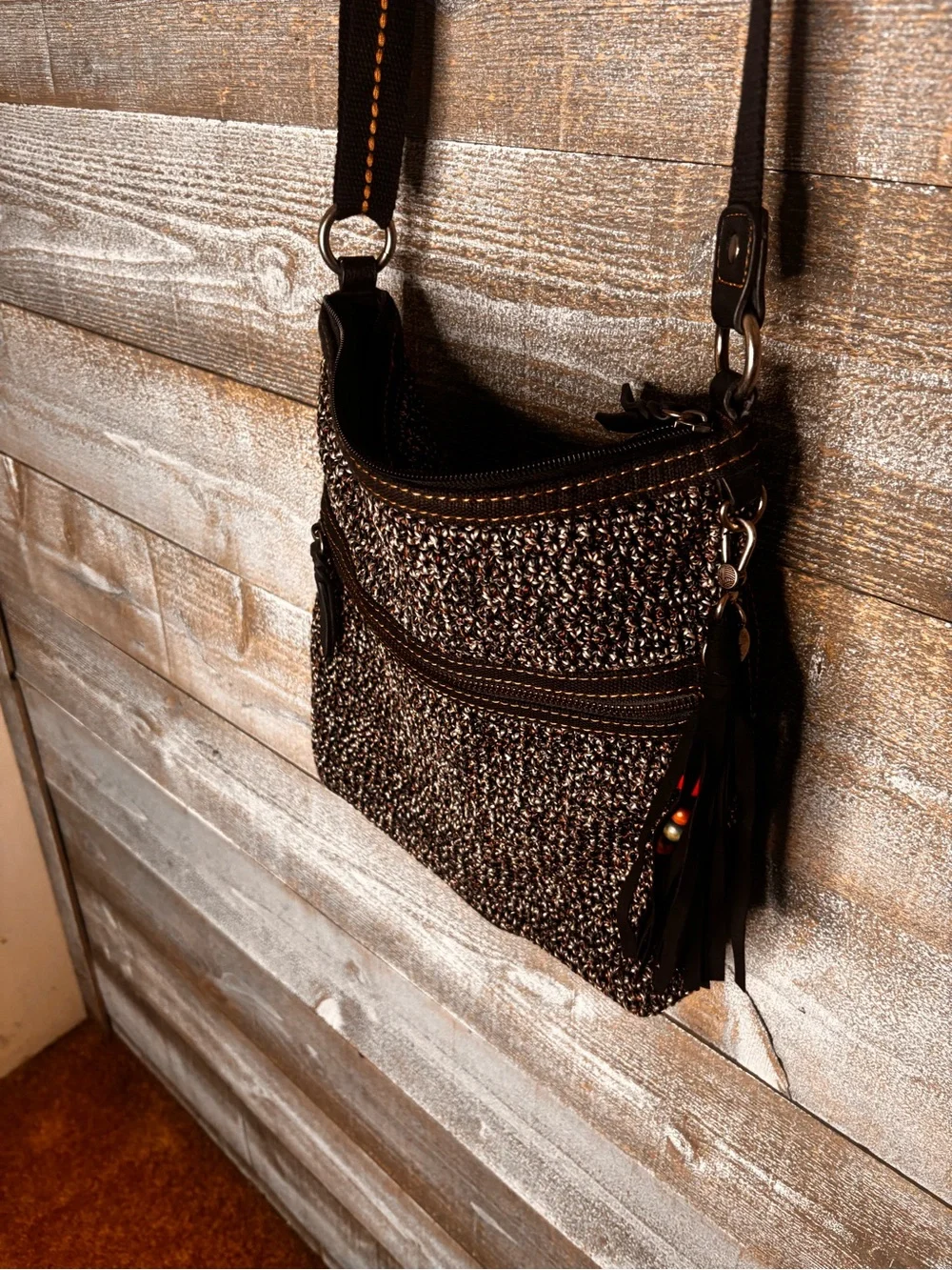 The Sak Urban Static Woven Crossbody Bag with Tassel Accent - Black grey